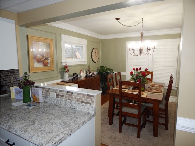 dining area featuring a notable chandelier and carpet flooring