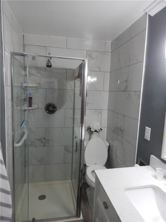 bathroom featuring walk in shower, vanity, and toilet