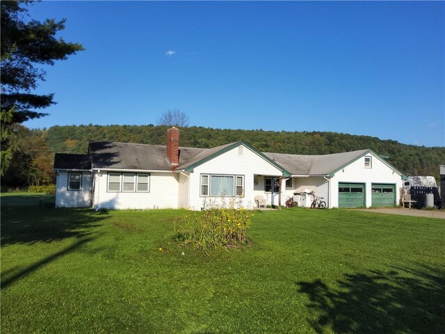 view of front of property featuring a garage and a front lawn