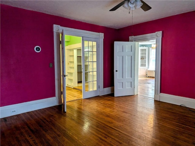 empty room with radiator, ceiling fan, a textured ceiling, and hardwood / wood-style flooring