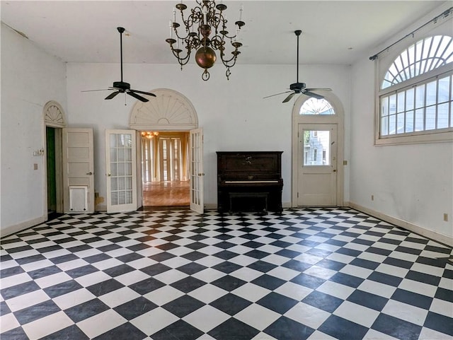 unfurnished living room with high vaulted ceiling and an inviting chandelier