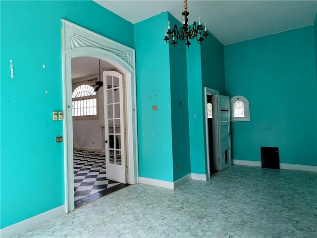 spare room with an inviting chandelier