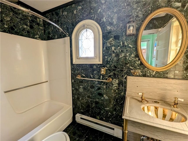 bathroom with sink, a baseboard radiator,  shower combination, and tile patterned flooring