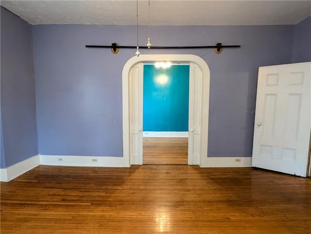 spare room with wood-type flooring and a textured ceiling