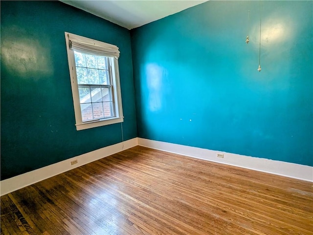 spare room with hardwood / wood-style floors