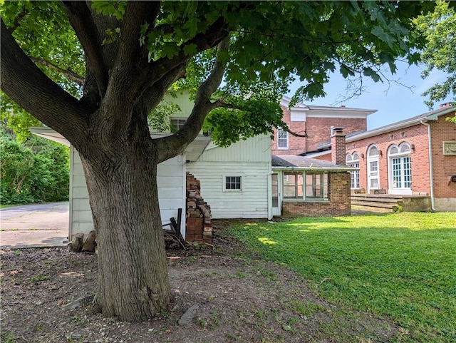 back of property featuring a lawn