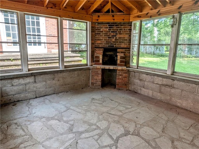 unfurnished living room featuring a fireplace and plenty of natural light