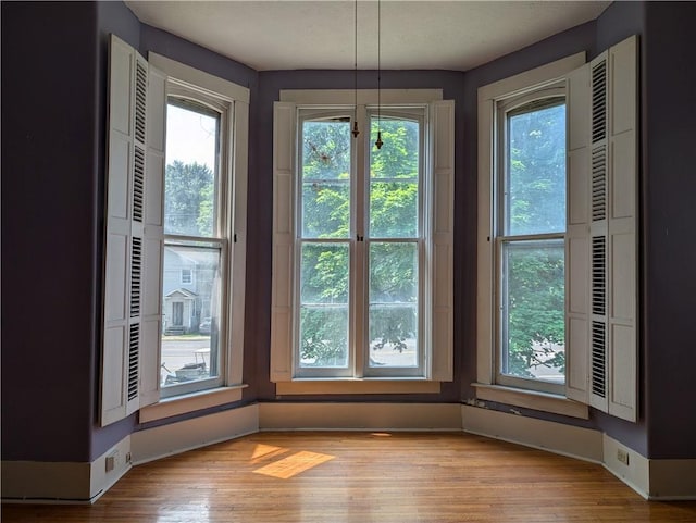 interior space with light hardwood / wood-style flooring and a healthy amount of sunlight