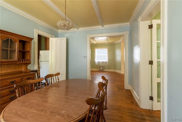 dining space with an inviting chandelier, ornamental molding, and hardwood / wood-style flooring