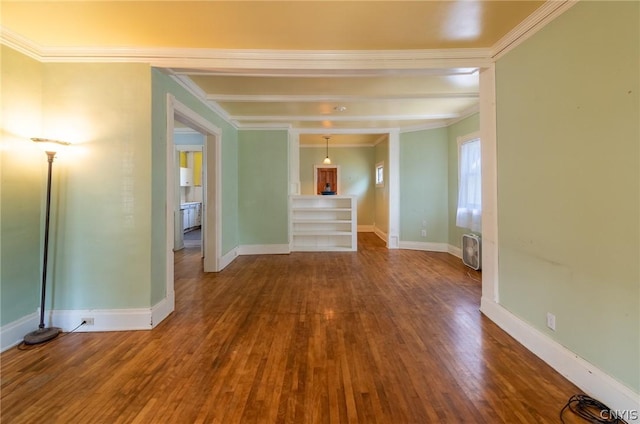 empty room featuring hardwood / wood-style floors and crown molding