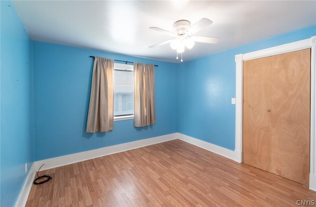 spare room with light wood-type flooring and ceiling fan