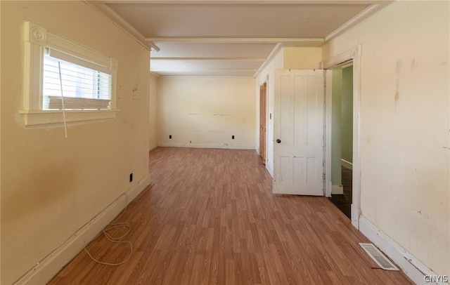 hallway with hardwood / wood-style flooring and crown molding