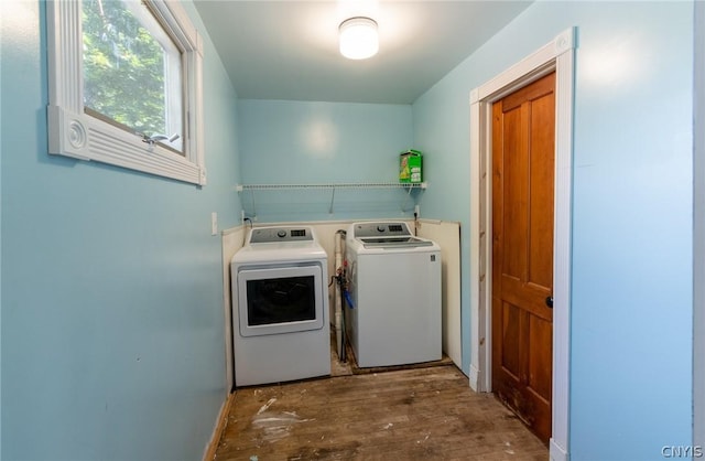 laundry room featuring washing machine and clothes dryer and dark wood-type flooring