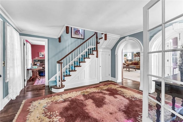 foyer featuring crown molding and dark hardwood / wood-style flooring