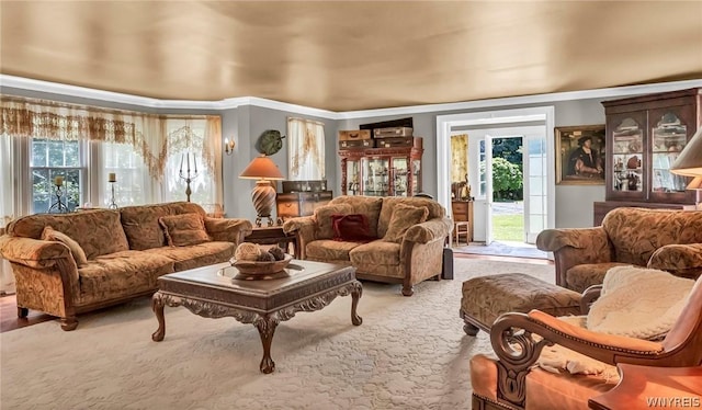 living area with crown molding and carpet flooring