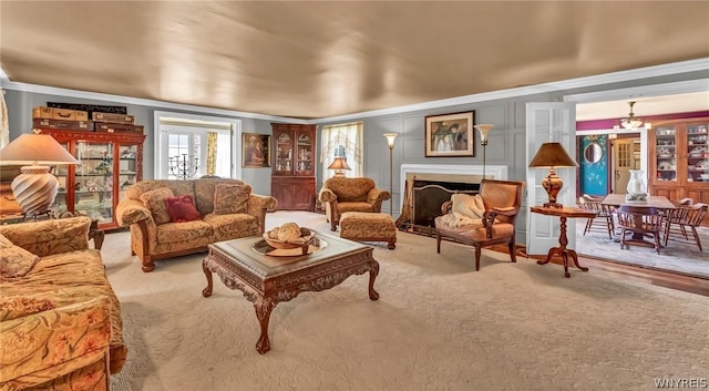 living room with ornamental molding and light colored carpet