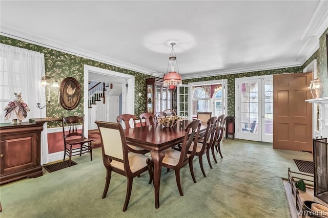 dining room with crown molding, carpet floors, and french doors