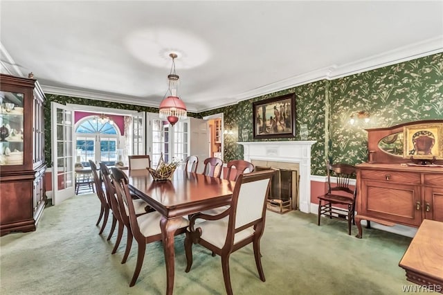 carpeted dining room featuring ornamental molding