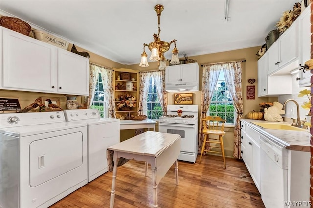 laundry area with separate washer and dryer, sink, light hardwood / wood-style flooring, and an inviting chandelier