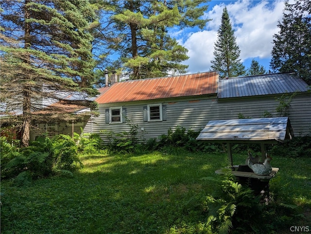 view of side of property with a lawn