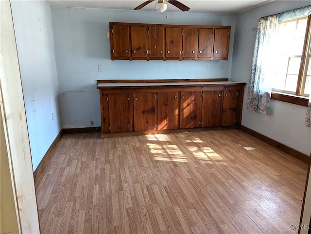 kitchen with ceiling fan and light hardwood / wood-style flooring