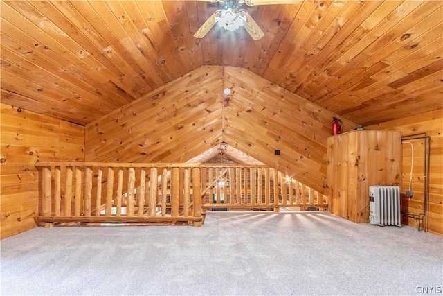 additional living space featuring radiator heating unit, wood ceiling, ceiling fan, vaulted ceiling, and carpet