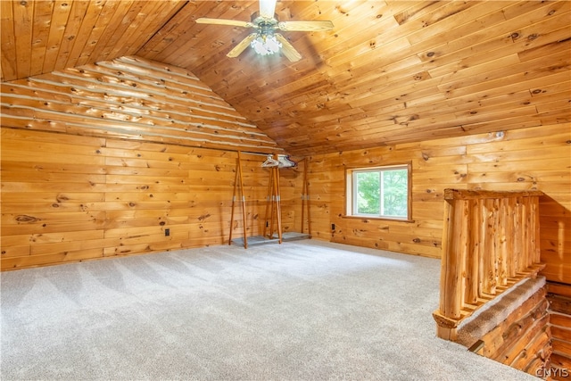 bonus room with wood walls, wood ceiling, carpet floors, ceiling fan, and vaulted ceiling