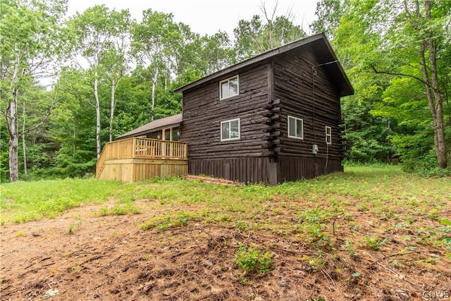 view of side of home with a wooden deck