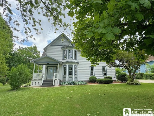 victorian home featuring a front yard and covered porch