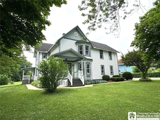 victorian-style house with a front yard