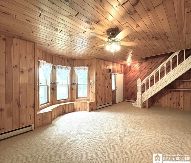 interior space featuring baseboard heating, carpet flooring, and wooden ceiling