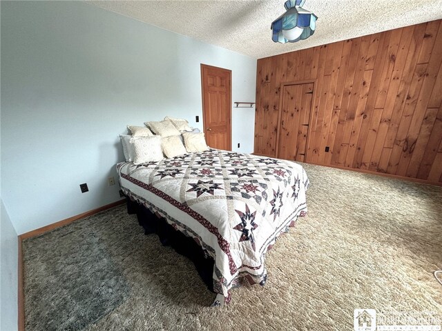 carpeted bedroom with a textured ceiling and wooden walls