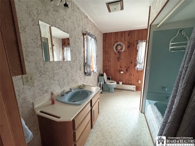 bathroom featuring vanity, a bath, toilet, and wood walls