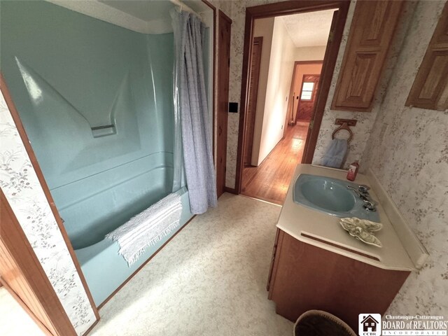 bathroom featuring vanity and shower / bath combo with shower curtain