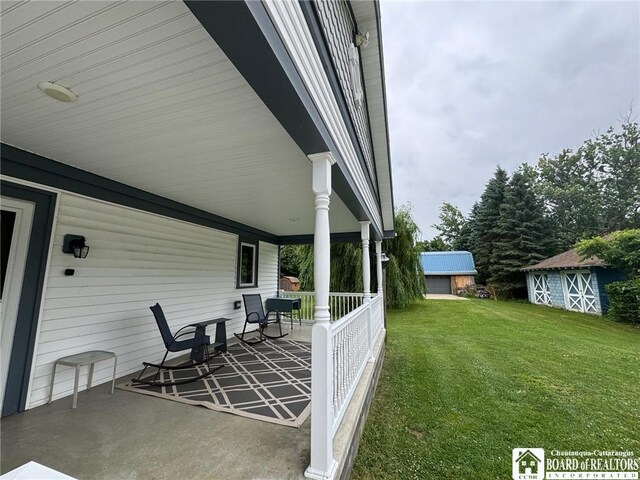 view of patio / terrace featuring covered porch and a storage shed