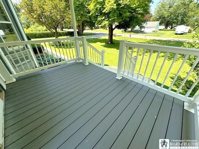 wooden deck featuring a yard