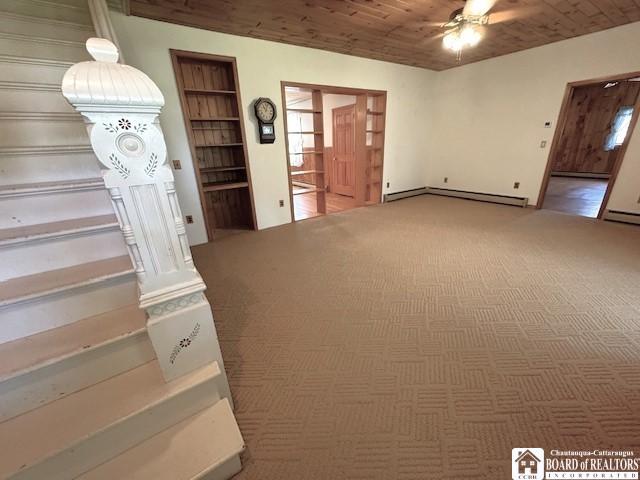 unfurnished living room with a baseboard radiator, carpet flooring, wooden ceiling, and ceiling fan