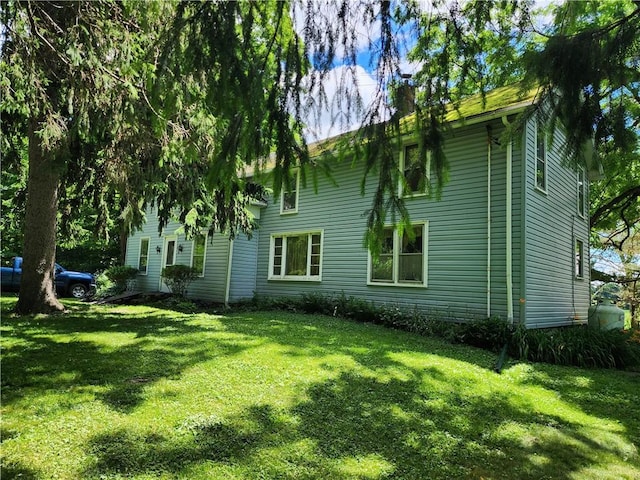 view of side of home featuring a lawn