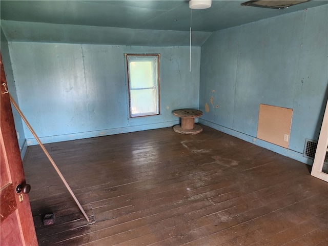 empty room featuring dark hardwood / wood-style flooring and lofted ceiling