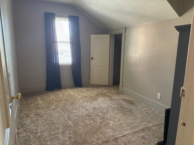 bonus room featuring carpet floors and vaulted ceiling