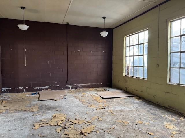 spare room with concrete block wall