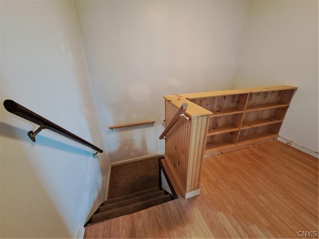 staircase with hardwood / wood-style flooring