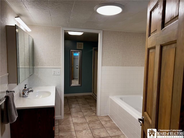 bathroom with tile patterned flooring, vanity, and plus walk in shower