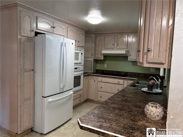 kitchen with sink, light brown cabinetry, and white appliances