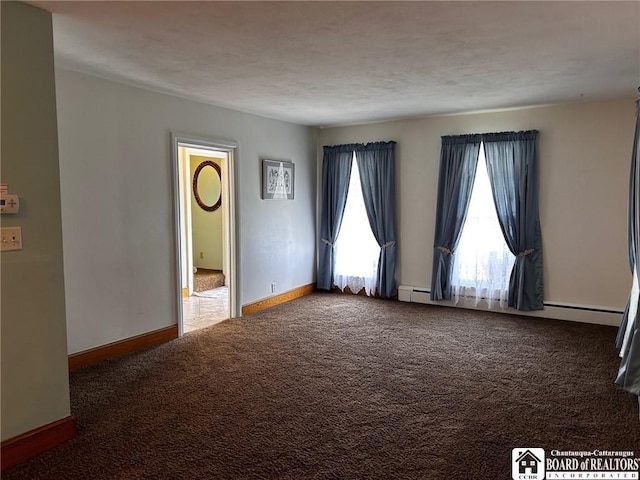 carpeted spare room with a baseboard radiator and a textured ceiling