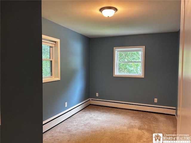 carpeted empty room with a baseboard radiator