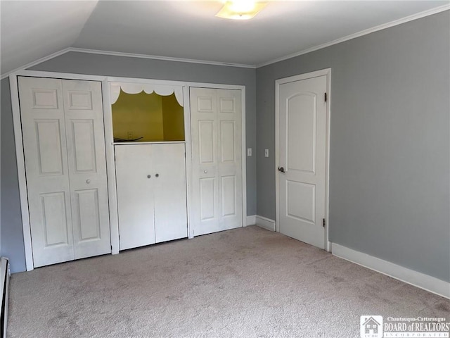 unfurnished bedroom featuring light carpet, crown molding, and lofted ceiling