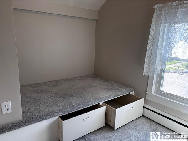 unfurnished bedroom with a baseboard radiator