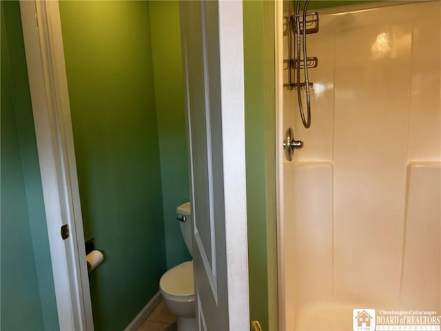 bathroom with walk in shower and toilet