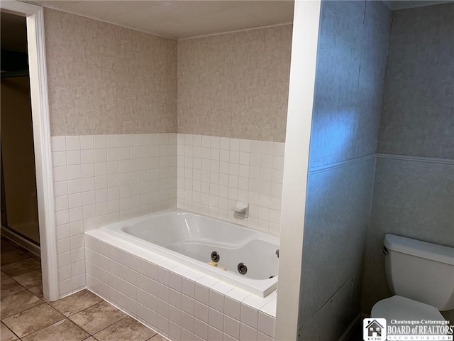 bathroom featuring tile patterned floors, toilet, and separate shower and tub